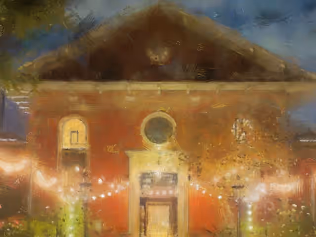Painterly view of the church's red-brick front at dusk, with a round window and doorway strung with festoon lights.