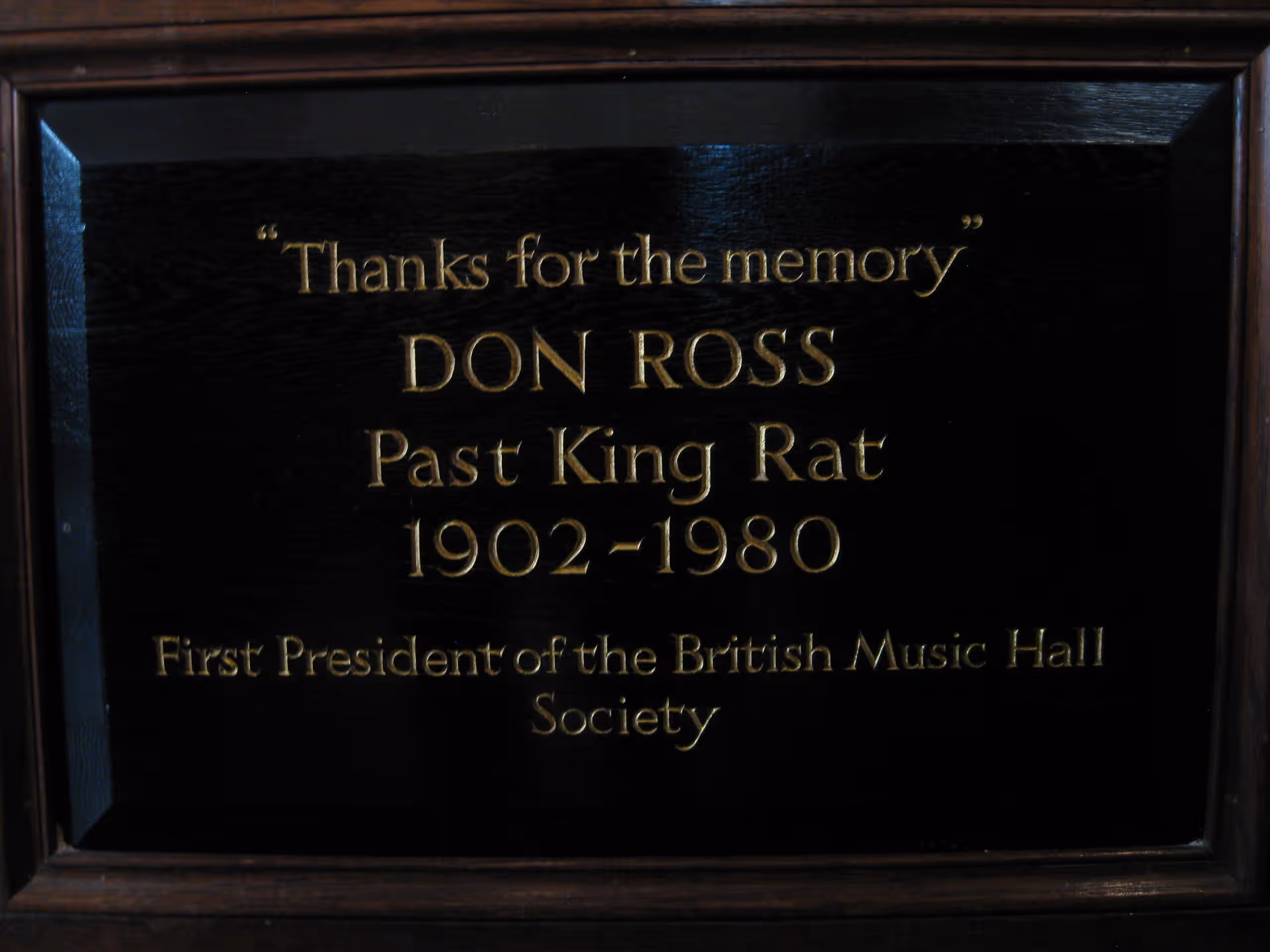 A black plaque with gold lettering: 'Thanks for the memory', Don Ross, Past King Rat, 1902–1980, First President of the British Music Hall Society.