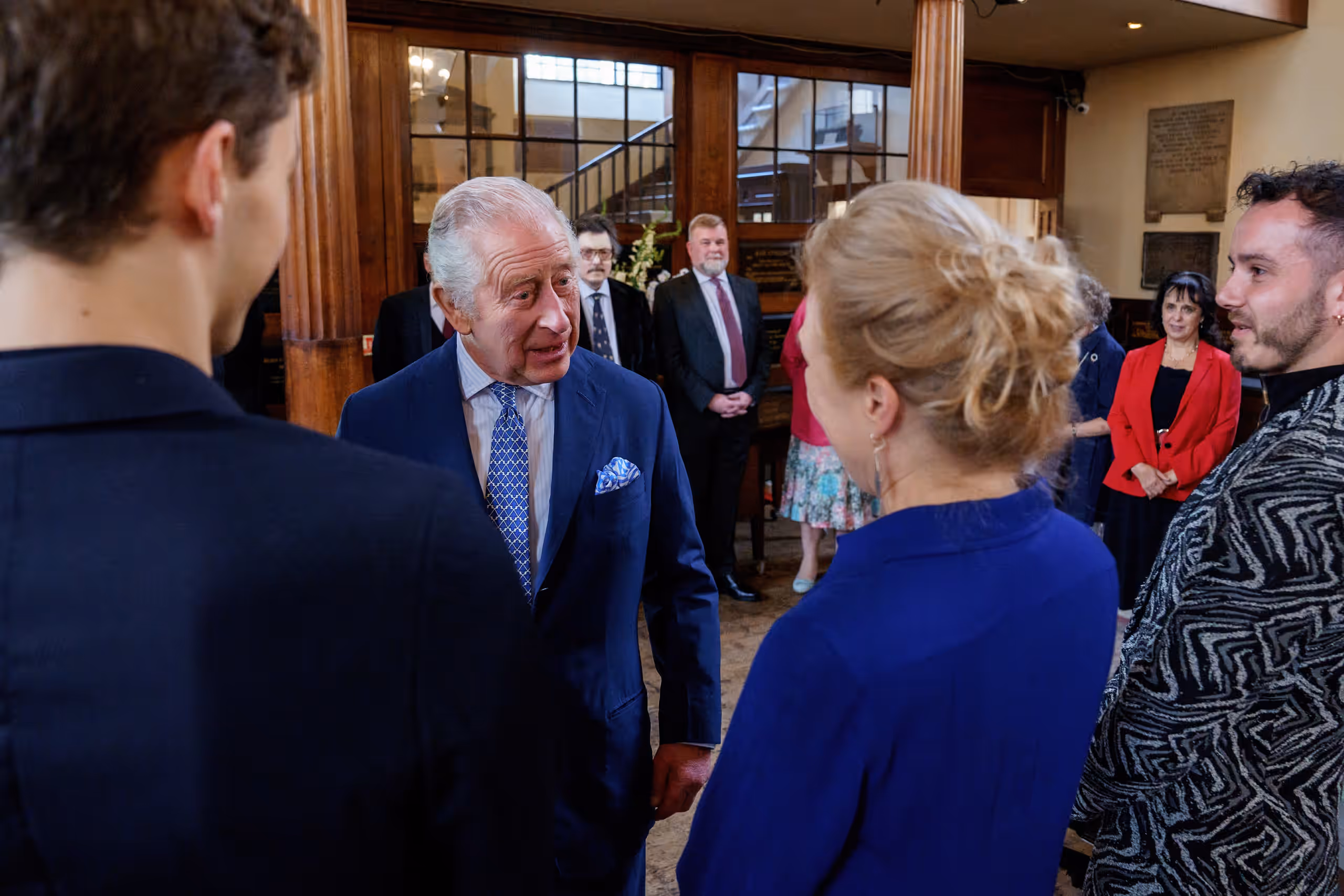 King Charles talks with theatre industry guests and members of the local community inside the church.