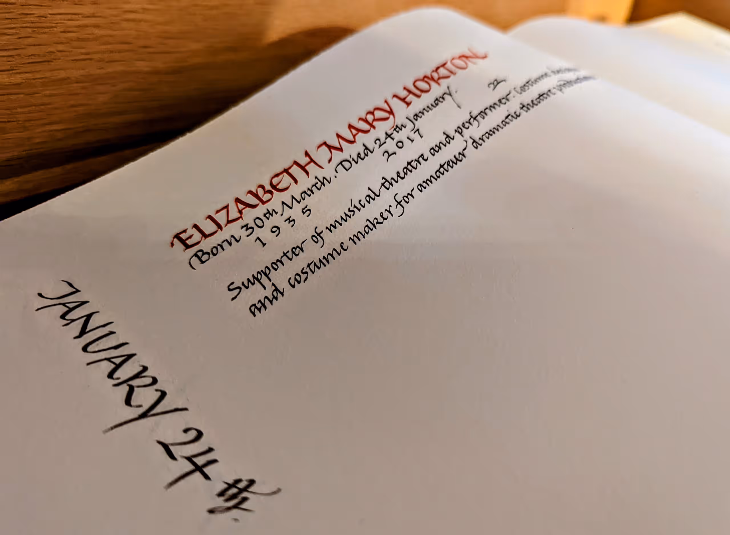 An open page of the Theatre Chaplaincy UK Memorial Book with a calligraphy entry for Elizabeth Mary Horton under January 24th.